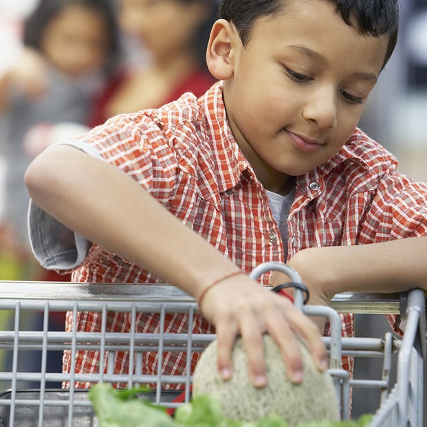 Boy putting product into cart
